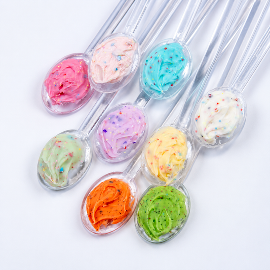 Close-up of nail swatch sticks featuring scoops of pastel whipped sprinkle gel colors.