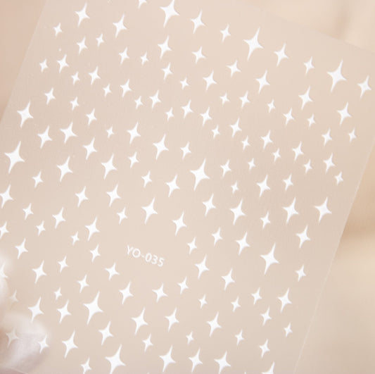 Sheet of soft white twinkling star and celestial nail stickers.