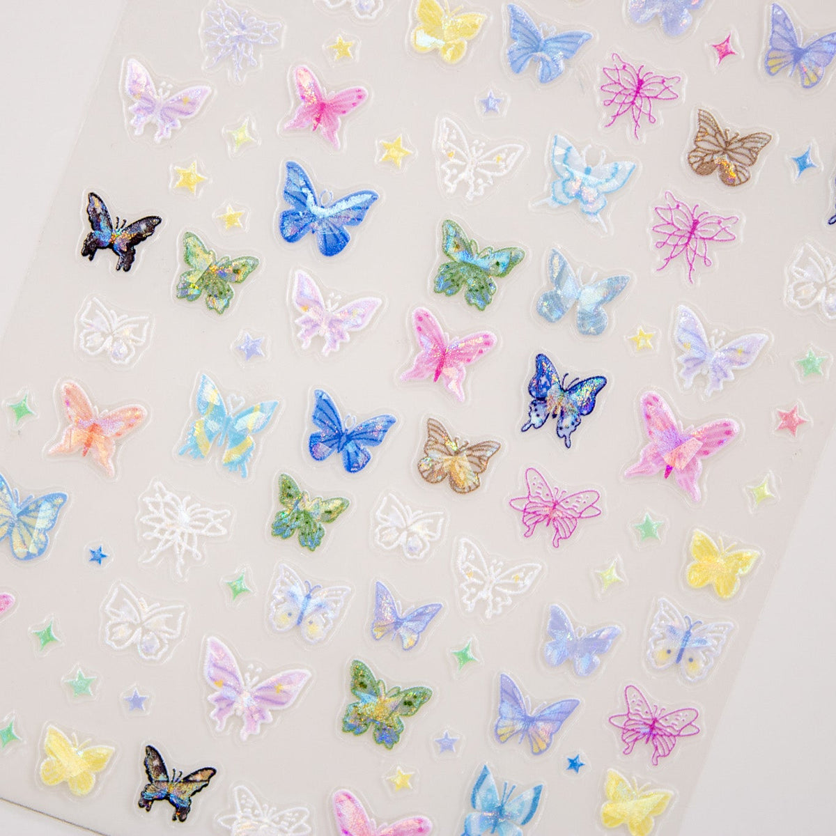 Full sheet of assorted pastel rainbow butterfly nail stickers.