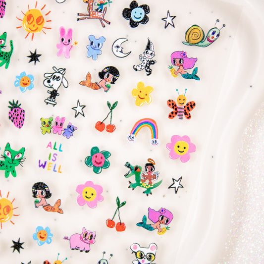 Close-up of retro doodle nail decals including green cats, rainbows, and flowers.