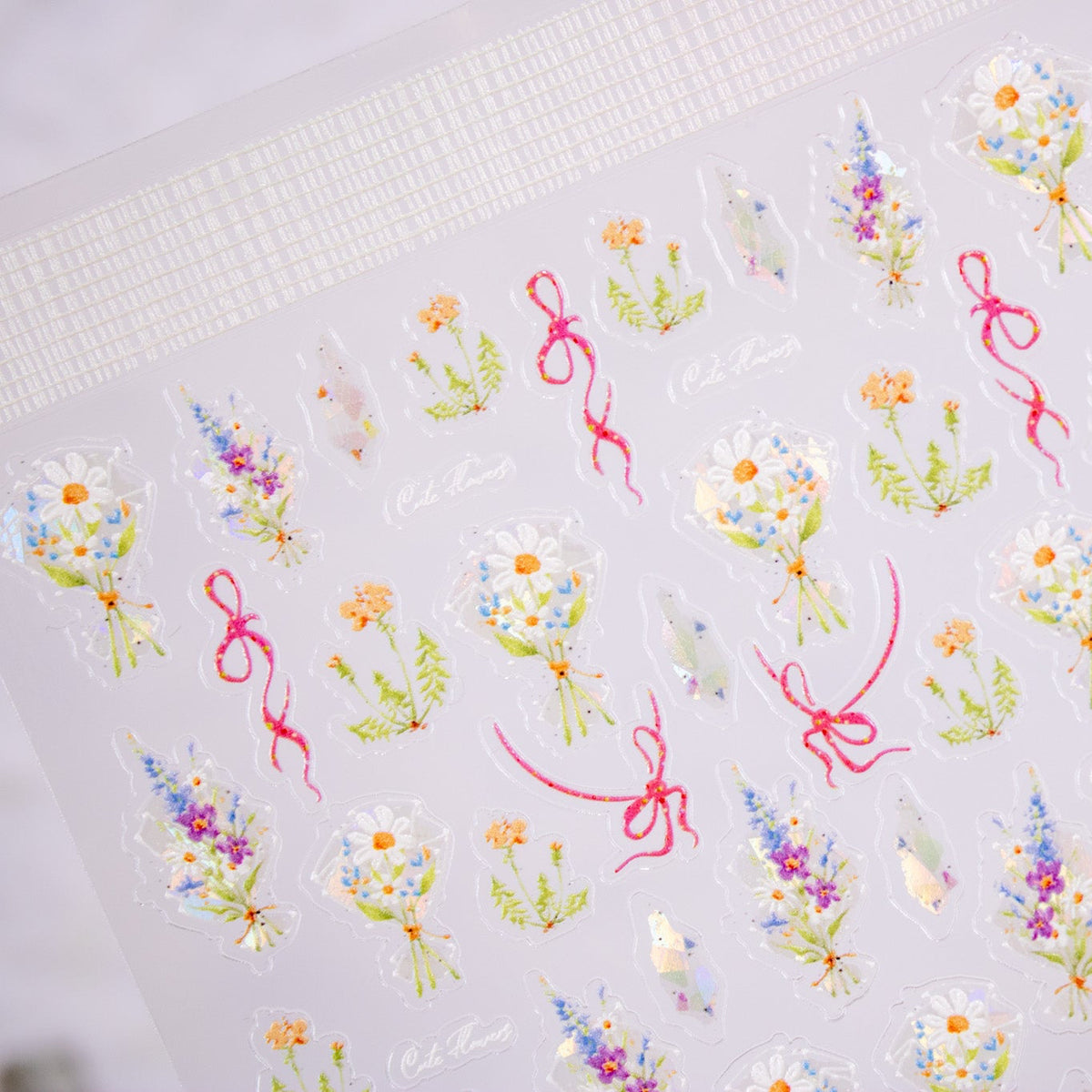Close-up angle showing delicate watercolor wildflower nail decals.