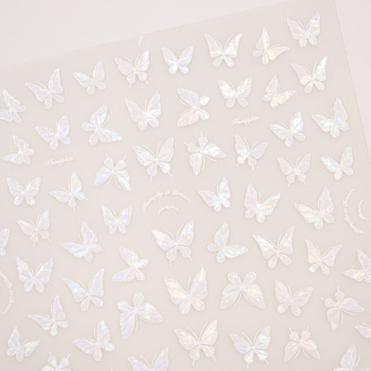 Close-up angle displaying pearlescent holographic butterfly nail decals.