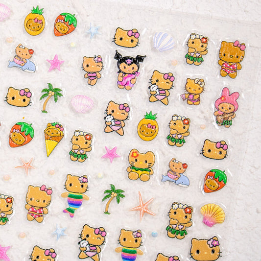 Close-up of summer kitty nail decals in swimsuits with pineapples and palm trees.