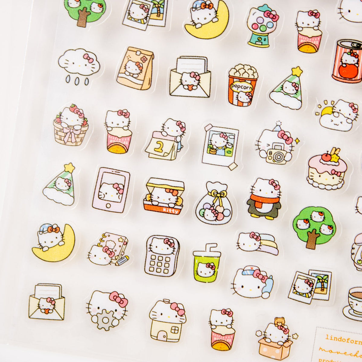Close-up of cute cat nail stickers featuring cakes, popcorn, and drinks.