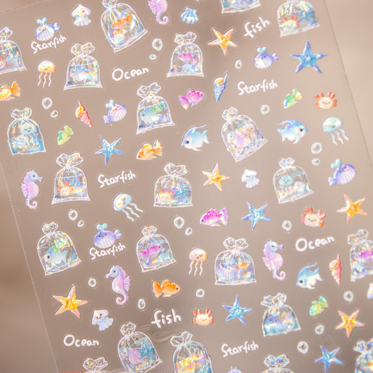 Angled close-up of cute sea creature and aquatic nail art decals.