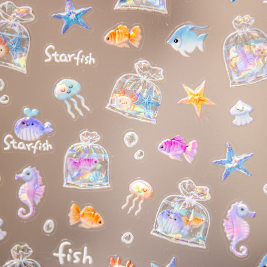 Close-up of sea life nail stickers featuring seahorses, whales, and jellyfish.