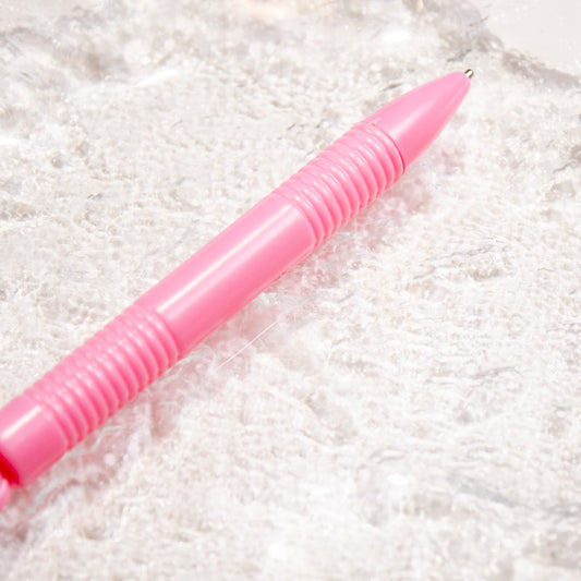 Pink magnetic nail art wand displayed flat against a neutral backdrop.