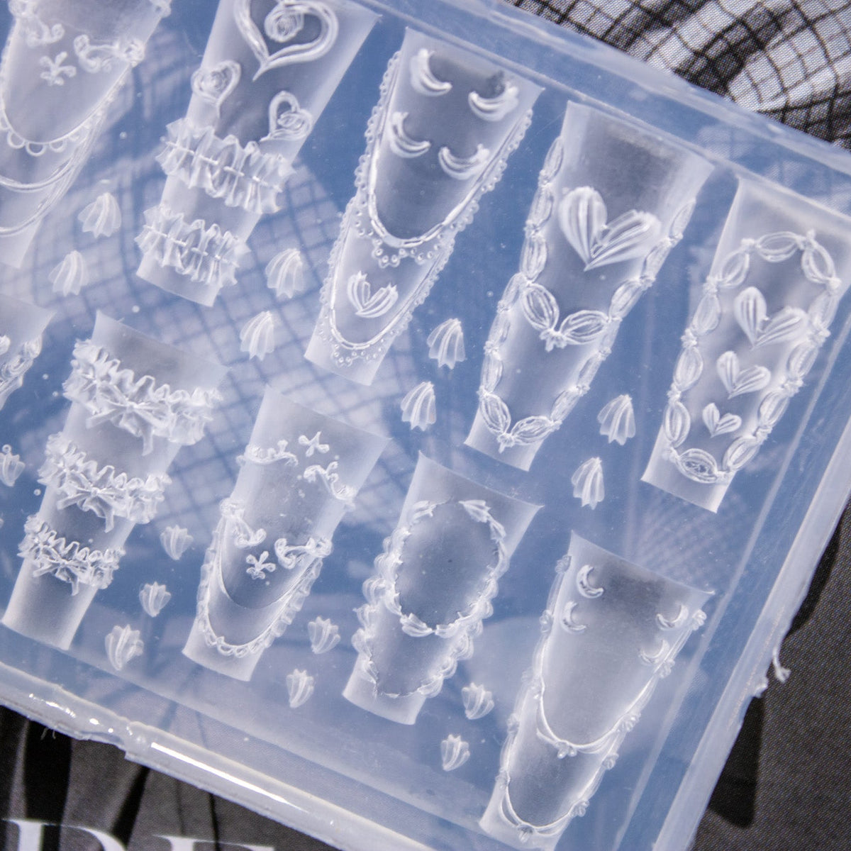 Top view showing the detailed rococo frame and cake frosting cavity shapes in clear silicone.