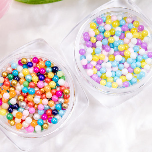 Top-down view of two jars displaying bright and soft pastel Tutti Frutti beads.