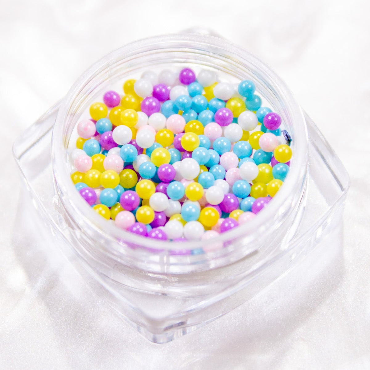 Close-up view of Tutti Frutti mini beads in soft pastel rainbow shades.