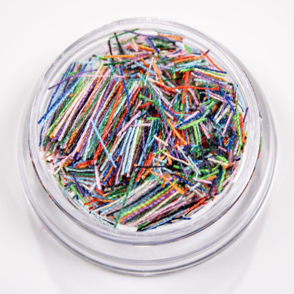 Close-up view of Dreamy Mix candy strip sprinkles featuring soft pastel blue, purple, and green tones.