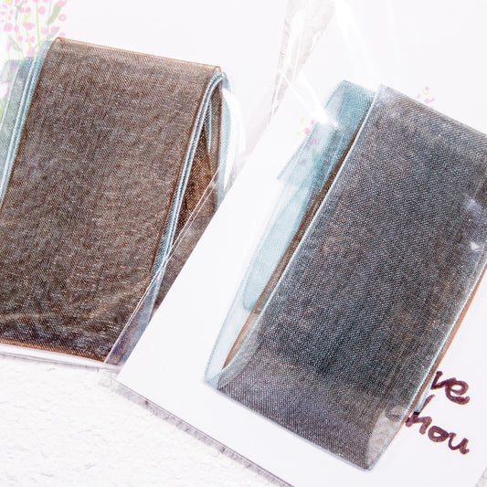 Sheer shimmer ribbon strips in both brown and blue sheer shimmer ribbon packaged side-by-side.
