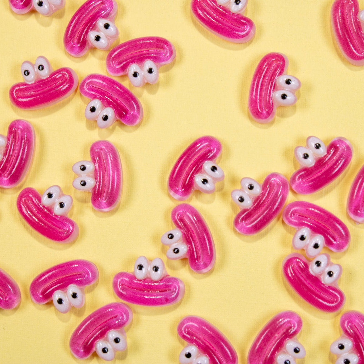 Pattern of pouty pink lips 3D nail charms scattered across a bright yellow background.
