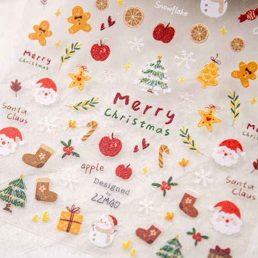 Angled view of a nail sticker sheet filled with holiday icons including gingerbread cookies, gifts, and candy canes.