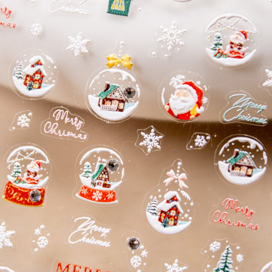 Angled shot of a sticker sheet packed with festive holiday decals including snow globes, trees, and reindeer.