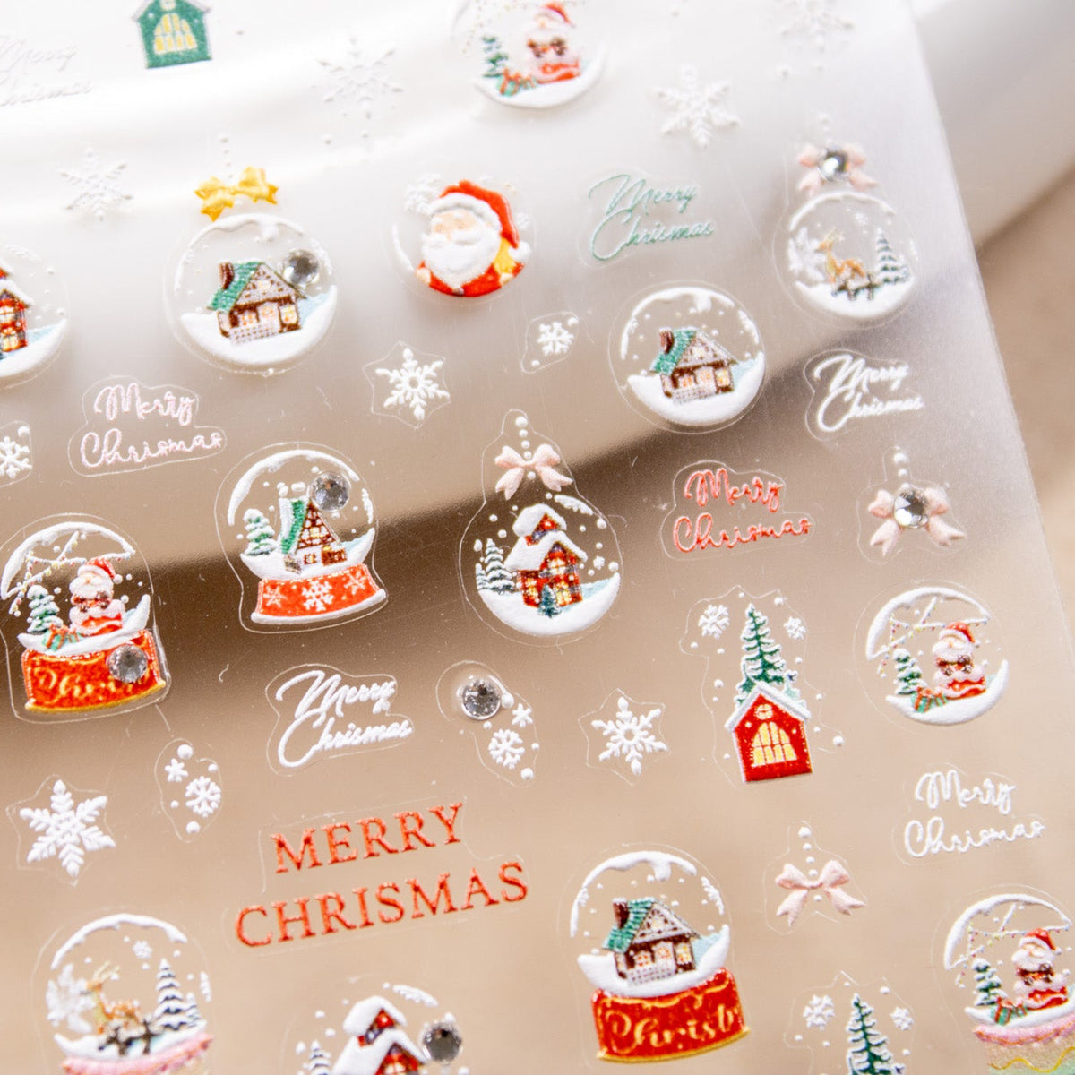 Angled close-up of sticker sheet featuring Merry Christmas lettering, stars, and snowflake designs.