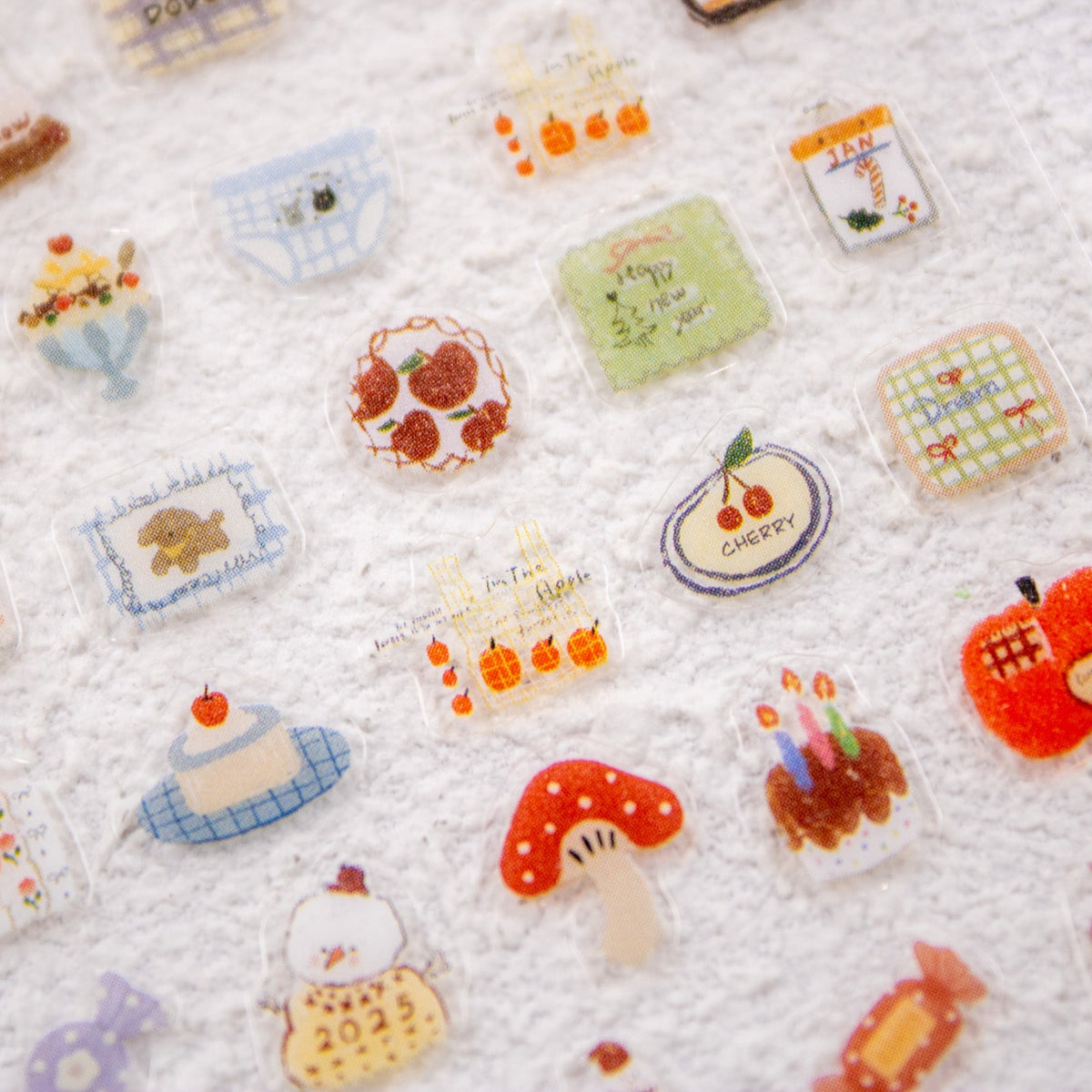 Full flat lay view of the Warm Wishes Nail Sticker sheet with various cozy winter and New Year designs.