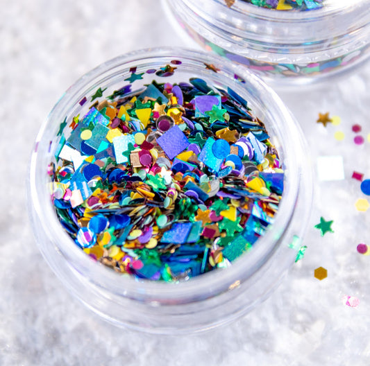 Close-up of open jar with colorful confetti nail art glitter mix.