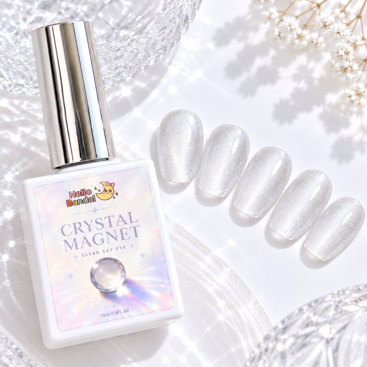 Bottle of Hello Bandal Crystal Magnet Gel next to five oval press-on nail swatches displaying a clear, shimmering magnetic cat eye effect on a white textured background.