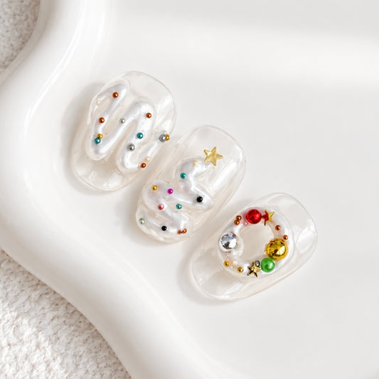 Pearlescent 3D squiggle and swirl nail art on clear nail tips decorated with colorful beads and gold charms