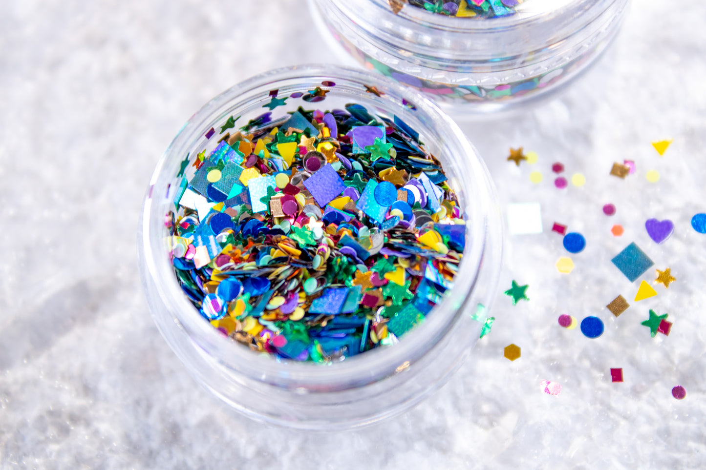 Colorful confetti nail glitter mix with stars, hearts, circles, and fun shapes.