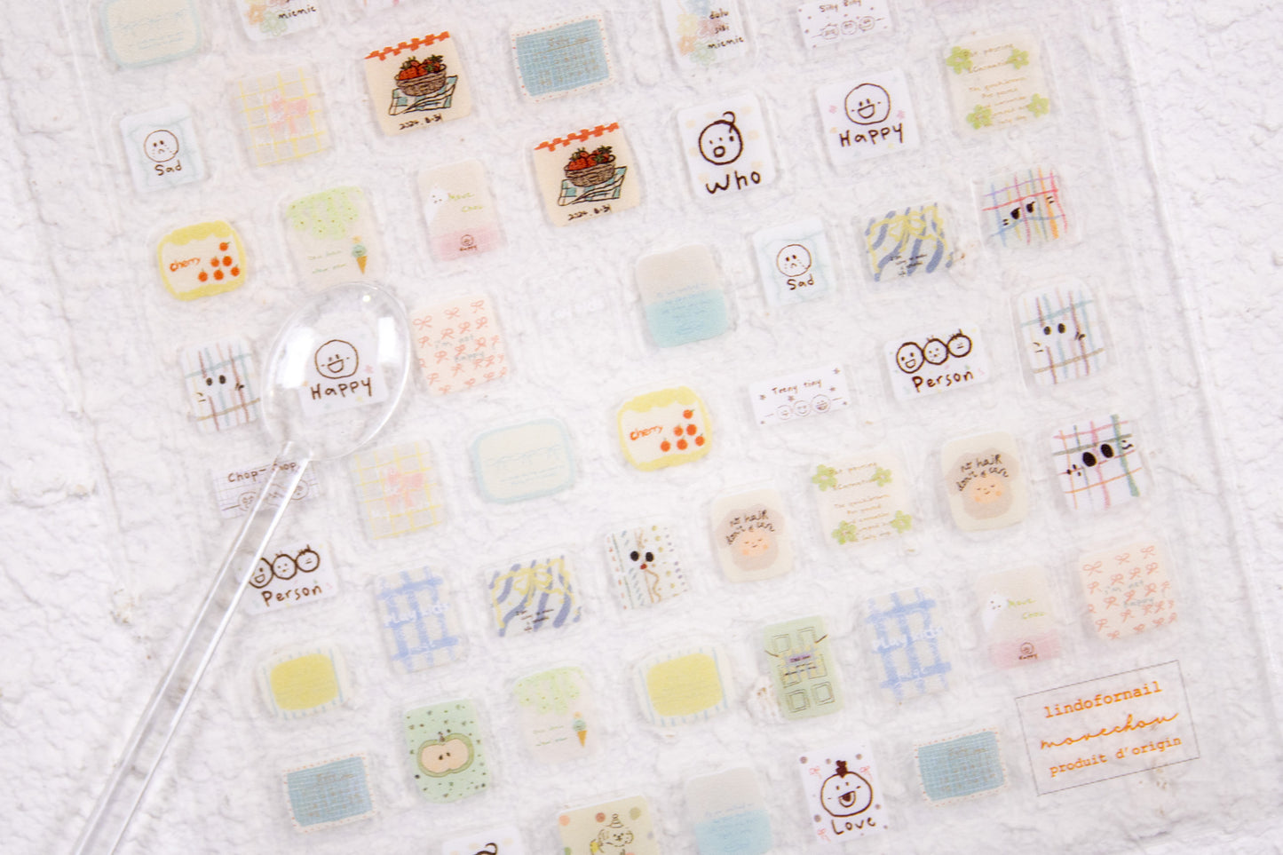 Cute doodle nail stickers featuring plaid patterns, hearts, flowers, and hand-drawn kawaii nail art designs.