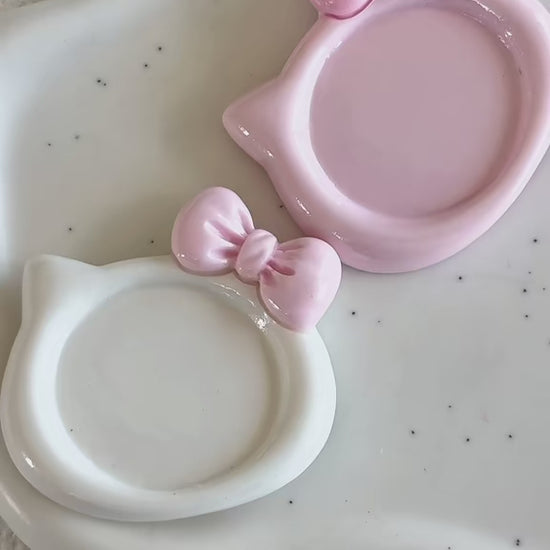 Demonstration video showing milky white and strawberry pink kitty-shaped resin nail art palettes being used to mix gel polish colors.