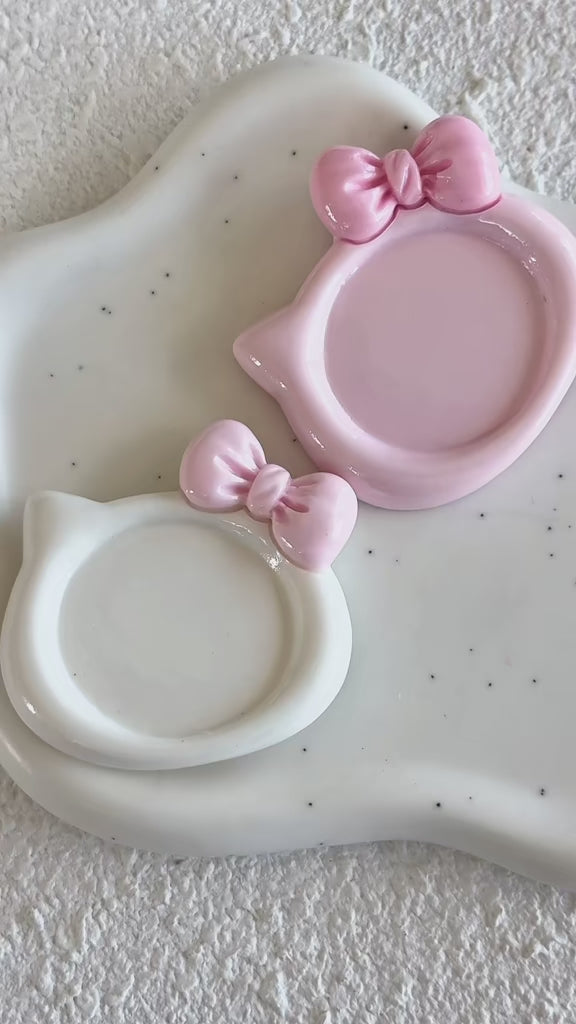 Demonstration video showing milky white and strawberry pink kitty-shaped resin nail art palettes being used to mix gel polish colors.